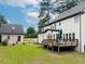Exterior view of the home features a wooden deck, lush green lawn, and mature landscaping at 3901 Phlox Rd, Raleigh, NC 27616