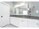 Bathroom featuring double sinks, granite counters, and a large mirror at 3901 Phlox Rd, Raleigh, NC 27616