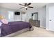 Bedroom features ceiling fan, dresser with a mirror, and a purple comforter on the bed at 3901 Phlox Rd, Raleigh, NC 27616