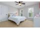 Bedroom features a ceiling fan, two windows, and a striped comforter at 3901 Phlox Rd, Raleigh, NC 27616