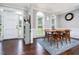 Formal dining room with hardwood floors, a modern table, and an exterior access door at 3901 Phlox Rd, Raleigh, NC 27616
