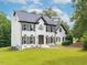 Charming two-story painted brick home with a manicured lawn at 3901 Phlox Rd, Raleigh, NC 27616