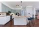 Modern kitchen with an island and breakfast bar, stainless appliances, and granite countertops at 3901 Phlox Rd, Raleigh, NC 27616