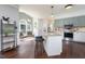 Modern kitchen with an island and breakfast bar, stainless appliances, and green accents at 3901 Phlox Rd, Raleigh, NC 27616