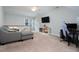 Bright living area features plush carpet, gray walls, and an abundance of natural light at 3901 Phlox Rd, Raleigh, NC 27616
