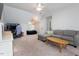 Spacious living room features plush carpet, gray walls, and an abundance of natural light at 3901 Phlox Rd, Raleigh, NC 27616