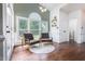 Sunroom with hardwood floors, lots of natural light, and comfortable chairs at 3901 Phlox Rd, Raleigh, NC 27616