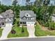 Aerial view of a beautiful home featuring manicured lawns, a spacious driveway, and an attached three-car garage at 4104 Green Chase Way, Apex, NC 27539