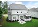 Exterior shot of home, landscaped lawn, patio with seating, grill and screened-in porch at 4104 Green Chase Way, Apex, NC 27539