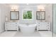 Luxurious bathroom with dual vanities and a freestanding soaking tub, perfect for relaxation at 4104 Green Chase Way, Apex, NC 27539
