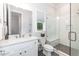 Bright bathroom featuring a white vanity, marble countertop, and a glass-enclosed shower with a built-in bench at 4104 Green Chase Way, Apex, NC 27539
