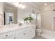 Well-lit bathroom featuring a white vanity, framed mirror, and a shower-tub combination at 4104 Green Chase Way, Apex, NC 27539