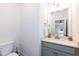 Bathroom featuring a vanity with gray cabinets, marble countertop, and gold fixtures at 4104 Green Chase Way, Apex, NC 27539
