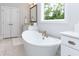 Elegant bathroom with a soaking tub, custom cabinets, and stylish fixtures offering comfort and style at 4104 Green Chase Way, Apex, NC 27539