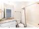 Bathroom with white vanity, decorative fixtures and a tub-shower with gray and white curtain at 4104 Green Chase Way, Apex, NC 27539