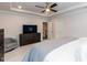 Tranquil bedroom complete with an entertainment center and cozy armchair, perfect for relaxation at 4104 Green Chase Way, Apex, NC 27539