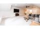 Open bonus room featuring plush carpeting, a ceiling fan, and a large screen TV for entertainment at 4104 Green Chase Way, Apex, NC 27539