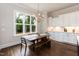 Bright dining area features a wooden table with bench, hardwood floors, and a large window at 4104 Green Chase Way, Apex, NC 27539