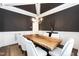 Elegant dining room featuring a striking black accent wall and a unique live edge wooden table at 4104 Green Chase Way, Apex, NC 27539