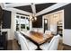 Stunning dining room featuring modern chandelier, large windows, and custom chairs around a wooden table at 4104 Green Chase Way, Apex, NC 27539