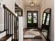 Elegant entryway featuring hardwood floors, staircase, and statement mirror, creating a welcoming ambiance at 4104 Green Chase Way, Apex, NC 27539