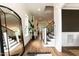 Bright and open entryway showcasing hardwood floors, a staircase, and a stylish mirror at 4104 Green Chase Way, Apex, NC 27539