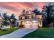 Charming two-story home with a stone and siding exterior, a welcoming front porch, and a spacious driveway at 4104 Green Chase Way, Apex, NC 27539
