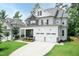 Beautiful two-story home with stone and siding, showcasing a well-maintained lawn and a two-car garage at 4104 Green Chase Way, Apex, NC 27539