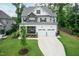 Attractive two-story home with stone detailing, a welcoming front porch, and a well-kept lawn at 4104 Green Chase Way, Apex, NC 27539