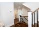 Hallway with wood floors, staircase with decorative railings, and views into other rooms at 4104 Green Chase Way, Apex, NC 27539
