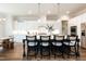 Modern kitchen featuring a large island with bar seating, pendant lighting, and stainless steel appliances at 4104 Green Chase Way, Apex, NC 27539