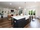 Spacious kitchen island with bar seating open to the living room with fireplace and built-in shelving at 4104 Green Chase Way, Apex, NC 27539