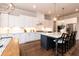 Beautiful kitchen featuring white cabinets, stainless steel appliances, and a large island with seating at 4104 Green Chase Way, Apex, NC 27539