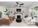 Bright living room features fireplace with built-ins, stylish furniture, and a modern ceiling fan at 4104 Green Chase Way, Apex, NC 27539
