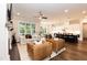 Open-concept living area showcasing a living room with fireplace and an adjacent, modern kitchen at 4104 Green Chase Way, Apex, NC 27539