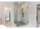 Modern shower enclosure featuring marble-look tile and bronze fixtures for a spa-like experience at 4104 Green Chase Way, Apex, NC 27539