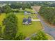 Aerial view of a home with a dark roof, surrounded by a large, green manicured lawn at 416 Fred Tew Rd, Dunn, NC 28334