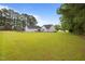 A home with fenced backyard on a large lot with lush green lawn at 416 Fred Tew Rd, Dunn, NC 28334
