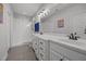Bright bathroom featuring double sinks, white cabinetry, and a walk-in shower with subway tile at 416 Fred Tew Rd, Dunn, NC 28334