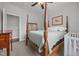 Comfortable bedroom with a four-poster bed, neutral carpet, and a view to the Bedroom at 416 Fred Tew Rd, Dunn, NC 28334
