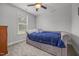 Inviting bedroom with a tufted daybed, soft carpet, and natural light from a window at 416 Fred Tew Rd, Dunn, NC 28334