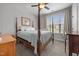 Cozy bedroom featuring a four-poster bed, soft carpet, and natural light from a window at 416 Fred Tew Rd, Dunn, NC 28334