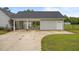 View of the exterior elevation showing a covered parking and white garage door at 416 Fred Tew Rd, Dunn, NC 28334
