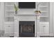 Close-up of the fireplace with built-in shelving and a mounted television at 416 Fred Tew Rd, Dunn, NC 28334