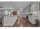Open concept kitchen features a large island with granite countertops, stainless appliances, and hardwood floors at 416 Fred Tew Rd, Dunn, NC 28334