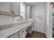 A laundry room featuring granite counters and dark hardwood floors at 416 Fred Tew Rd, Dunn, NC 28334