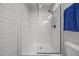 Modern walk-in shower with white subway tile, glass door, and stylish fixtures at 416 Fred Tew Rd, Dunn, NC 28334