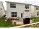 Spacious backyard area with a stone patio, beautiful landscaping, and a grill at 4179 Dunkirk Dr, Burlington, NC 27215