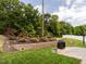 Backyard with a stone patio, landscaping, and a grill at 4179 Dunkirk Dr, Burlington, NC 27215