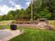 Backyard with a stone patio, landscaping, and a grill at 4179 Dunkirk Dr, Burlington, NC 27215